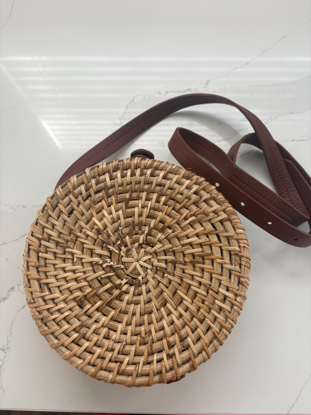 Straw rattan bag with brown leather strap 
Blue striped interior 
Like new
$30